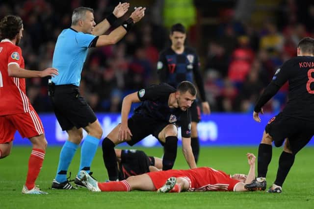 Rangers defender Borna Barisic checks on Daniel James after the Manchester United youngster suffered a suspected head knock in Wales' match with Croatia