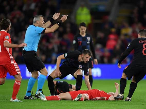 Rangers defender Borna Barisic checks on Daniel James after the Manchester United youngster suffered a suspected head knock in Wales' match with Croatia