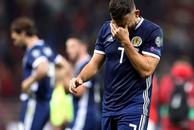 Robert Snodgrass cuts a dejected figure after Scotland's 4-0 defeat in Moscow.