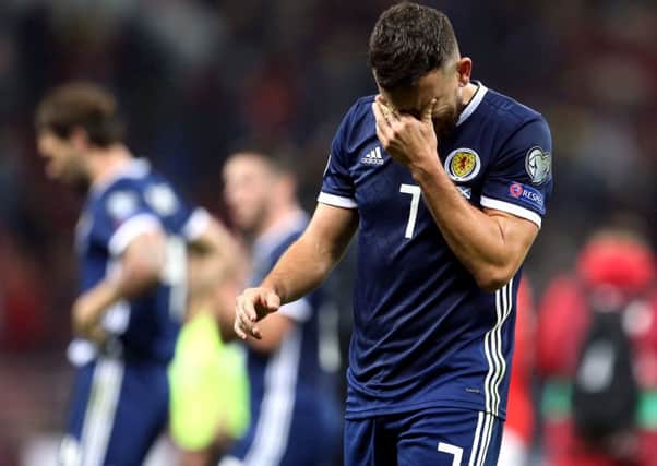 Robert Snodgrass cuts a dejected figure after Scotland's 4-0 defeat in Moscow.