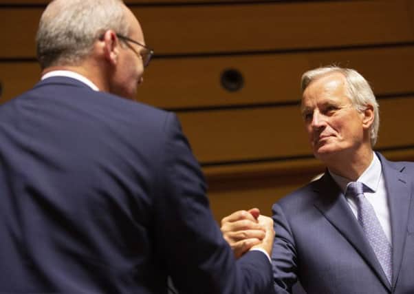 Brussels chief negotiator Michel Barnier with Irish Foreign Minister Simon Coveney. Picture: AP