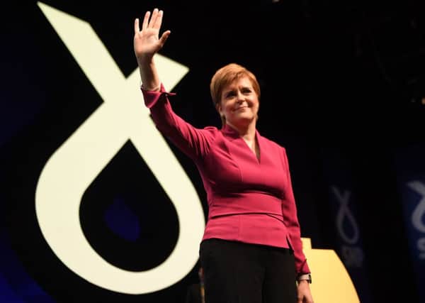 Nicola Sturgeon waves after delivering her speech at the annual SNP conference (Picture: Andy Buchanan/AFP via Getty Images)
