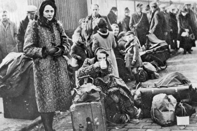 A woman waited in line to be evacuated following the bombing raids on Clydebank in March 1941. PIC: West Dunbartonshire Council.