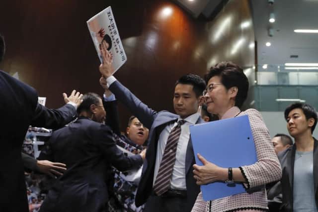 Hong Kong Chief Executive Carrie Lam, center right, arrives at chamber of the Legislative Council in Hong Kong. (AP Photo/Kin Cheung)