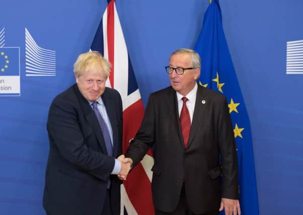 Done deal? Boris Johnson and Jean-Claude Juncker, President of the European Commission, shake hands  (Picture: Stefan Rousseau/PA Wire)