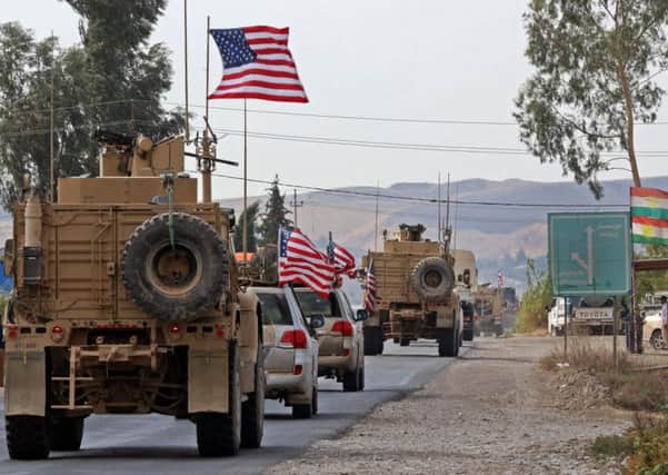 A convoy of US military vehicles arrives near the Iraqi Kurdish town of Bardarash, Dohuk, on Monday, after withdrawing from northern Syria (Picture: Safin Hamed/AFP via Getty Images)
