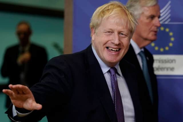 Boris Johnson grins after negotiating his new Brexit deal with the EU (Picture: Kenzo Tribouillard/AFP via Getty Images)