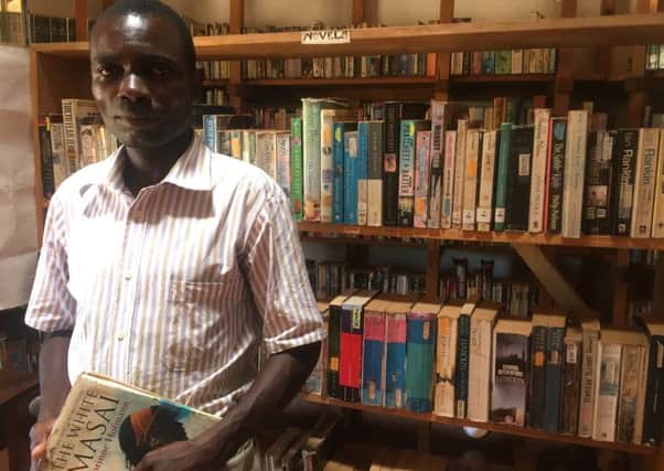 Librarian Burton Chirwa among the thousands of books in his village library in Mwaya (Picture: Susan Dalgety)