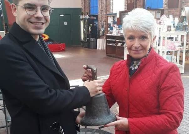 The bell from the MV Kyles, which is believed to be the oldest Clyde-built vessel still afloat in the UK, is held by Scottish Maritime Museum curator Matthew Bellhouse Moran (left) and Carole Harries (right), who donated it to the museum after finding it in her garage in Glamorganshire in South Wales.