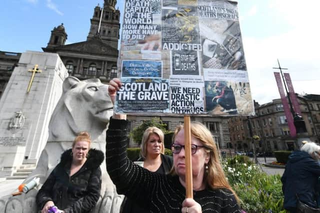 A mother holds a placard at the event. Drug death gathering  held in Glasgow City Centre for International Overdose Awareness Day. Picture: John Devlin