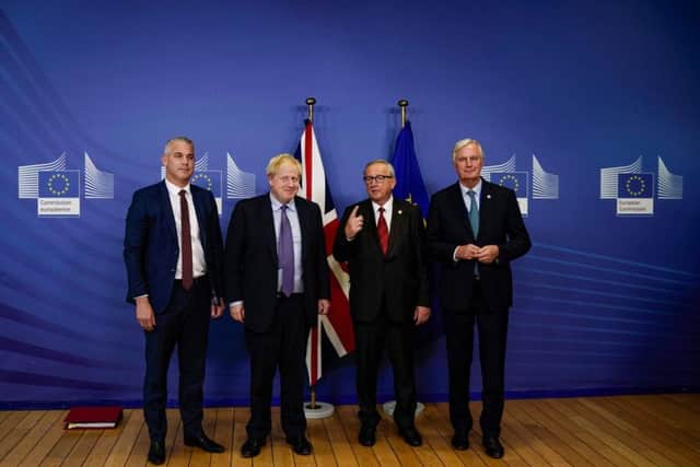 British Prime Minister Boris Johnson (2L) poses with President of the European Commission Jean-Claude Juncker (2R) and EU chief Brexit negotiator Michel Barnier (R) and Britain's Brexit Minister Stephen Barclay (L) as they prepare to address a press conference at a European Union Summit at European Union Headquarters in Brussels on October 17, 2019. (Photo by Kenzo TRIBOUILLARD / AFP) (Photo by KENZO TRIBOUILLARD/AFP via Getty Images)