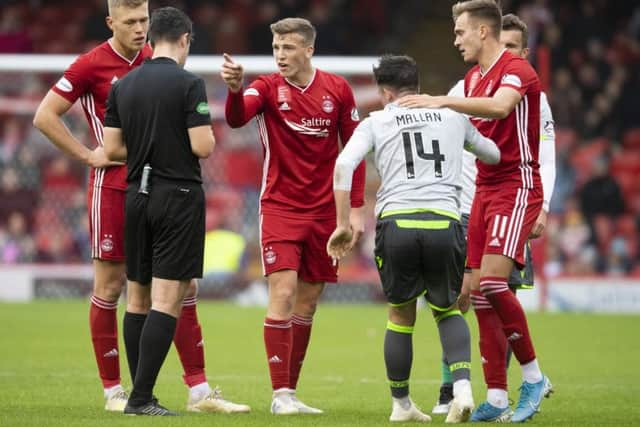 Lewis Ferguson, centre, will miss Aberdeen's game with Motherwell after being sent off against Hibernian. Picture: Craig Williamson/SNS