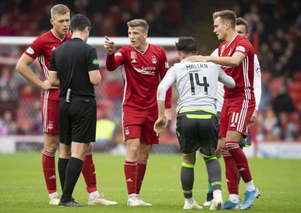 Lewis Ferguson, centre, will miss Aberdeen's game with Motherwell after being sent off against Hibernian. Picture: Craig Williamson/SNS