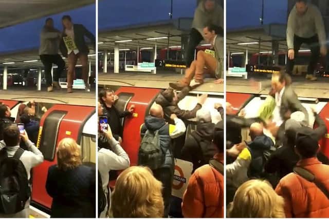 The moment an angry mob of commuters dragged Extinction Rebellion protestors off the top of a London Underground train at Canning Town station, east London.
