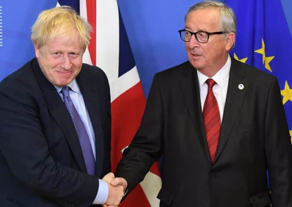 Done deal? Boris Johnson and European Commission President Jean-Claude Juncker shake hands (Picture:: Stefan Rousseau/PA Wire)