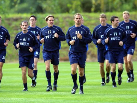 Fernando Ricksen (left), and Ronald de Boer lead the way at a Rangers training session in August 2001