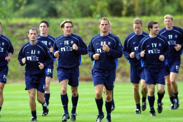 Fernando Ricksen (left), and Ronald de Boer lead the way at a Rangers training session in August 2001