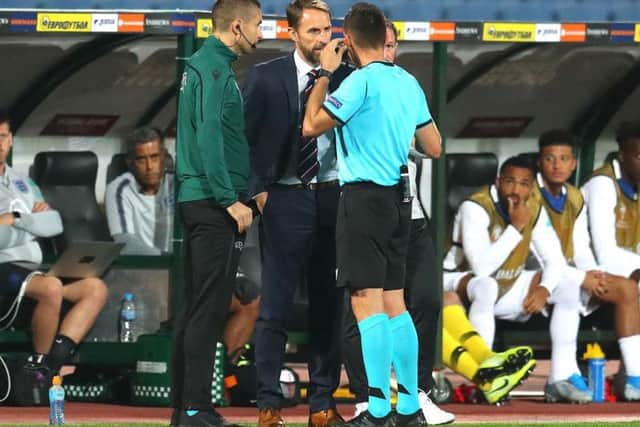 England boss Gareth Southgate speaks with referee Vasil Levski as racist chanting halts his side's match with Bulgaria.