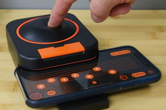 Skwitch, described as a one-button music-making gadget and app, links to the users iPhone. Picture: Contributed