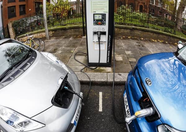Go Ultra Low Nissan LEAF (L) and Kia Soul EV (R) on charge on a London street. Ultra-low emission vehicles such as this can cost as little as 2p per mile to run and some electric cars and vans have a range of up to 700 miles.