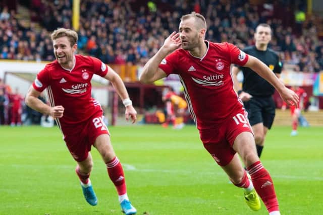 Niall McGinn wheels away in celebration after netting Aberdeen's second of the afternoon