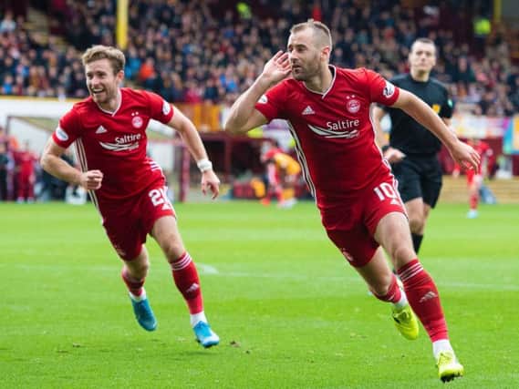 Niall McGinn wheels away in celebration after netting Aberdeen's second of the afternoon