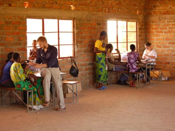 Dr Gavin McColl working in a clinic in Zambia.