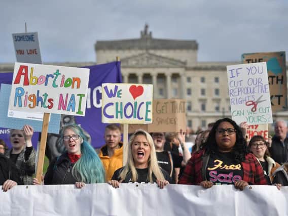 Abortion-rights demonstrators march through the streets of Belfast ahead of the meeting of the Stormont Assembly.