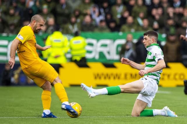 Celtic's Ryan Christie slides into a challenge on Livingston's Scott Robinson which earned a straight red card. Picture: Alan Harvey/SNS