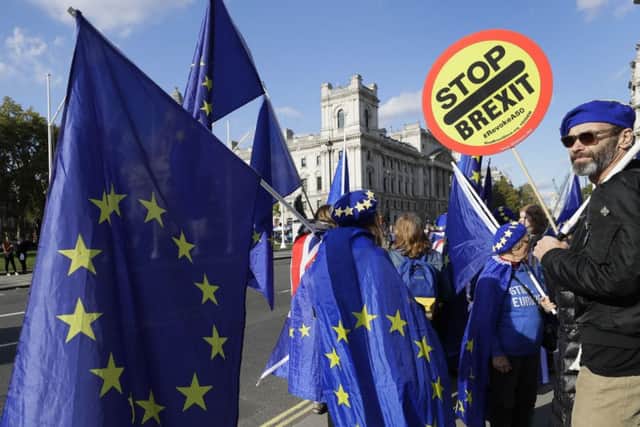 Anti Brexit demonstrators hold European Union flags near Parliament in London. (AP Photo/Kirsty Wigglesworth)