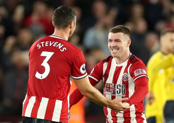 Sheffield United's Enda Stevens, left, and John Fleck celebrate after their 1-0 victory over Arsenal.