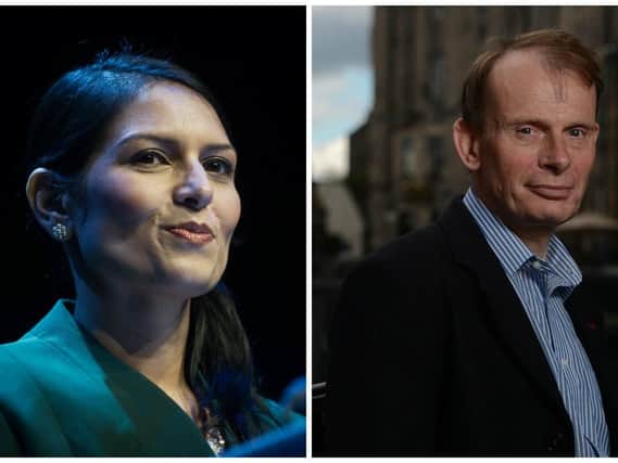 The BBC has apologised after host Andrew Marr (right) accused home secretary Priti Patel (left) of laughing over an on-air Brexit exchange