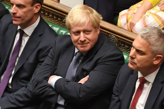 Prime Minister Boris Johnson (centre) flanked by Dominic Raab and Stephen Barclay