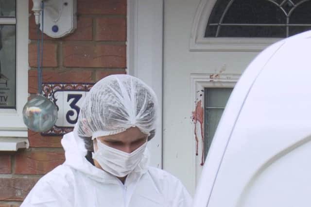 Forensic officers at the scene of the stabbings in Milton Keynes