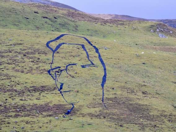The portrait of the poet Hamish Henderson takes shape at the Spittal of Glenshee to mark what would have been his 100th birthday next month. PIC: Clare Cooper.