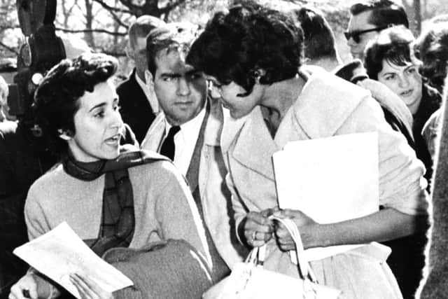 Kathryn Johnson, left, impersonates a student to get close to Charlayne Hunter on her  first day at the University of Georgia. Picture: AP
