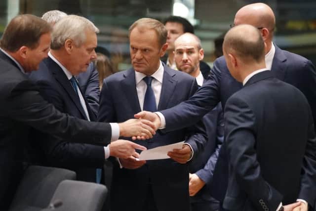 EU Council president Donald Tusk talks to fellow European leaders