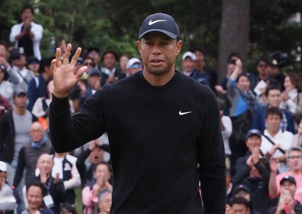 Tiger Woods acknowledges the fans on the 5th green in the first round of the Zozo Championship. Picture: Toshifumi Kitamura/AFP/Getty