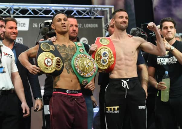 Regis Prograis, left, and Josh Taylor show off their respective world title belts during the weigh-in at Canary Wharf, London. Picture: TGS Photo/Shutterstock