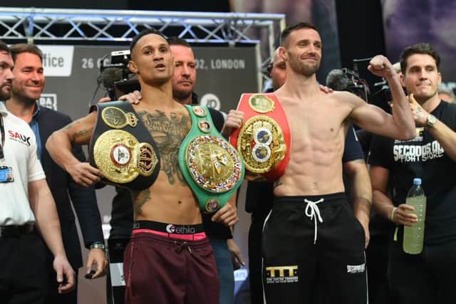 Regis Prograis, left, and Josh Taylor show off their respective world title belts during the weigh-in at Canary Wharf, London. Picture: TGS Photo/Shutterstock