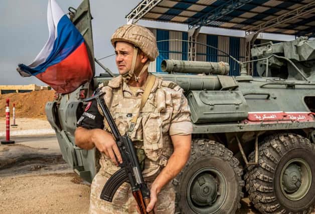 A member of the Russian military police stands outside an armoured personnel carrier at a position along the Syria-Turkey border. James Le Mesurier, who was found dead, helped found the White Helmets volunteer organisation in Syria. Picture: Delil Souleiman/Getty Images