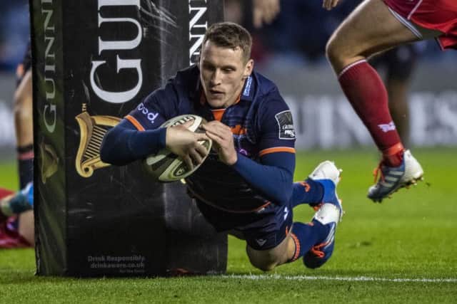 Mark Bennett dives over for a first-half try in Edinburgh's thumping win over Scarlets at Murryafield. Picture: Gary Hutchison/SNS