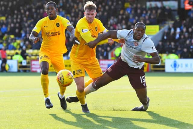 Hearts striker Uche Ikpeazu and Livingstons Alan Lithgow tangle in the box during the 1-1 draw. Picture: SNS.