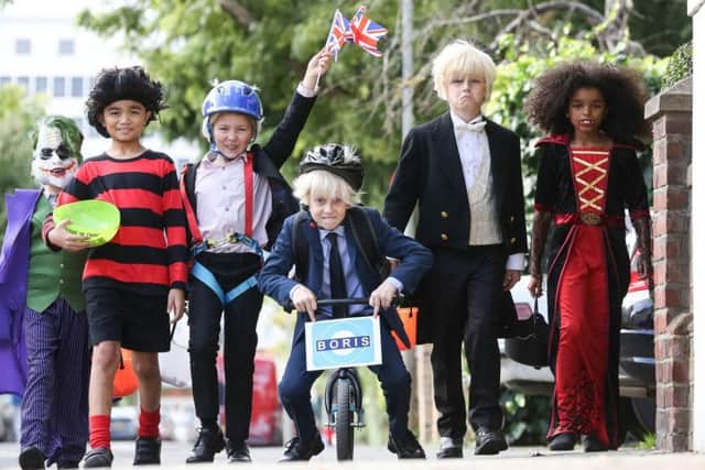 Children dressed up as three of the Prime Minister's most iconic looks; 'Zipwire Boris', 'Biking Boris' and 'Bullingdon Boris' to celebrate a Beano Halloween. Picture: PA