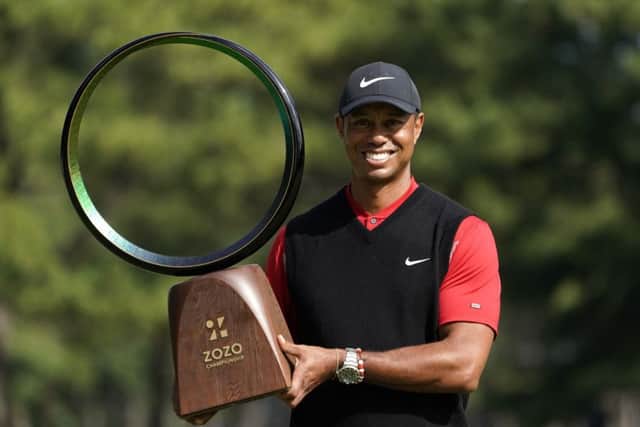 Tiger Woods shows off the trophy after his win in the Zoxo Championship in Japan. Picture: AP
