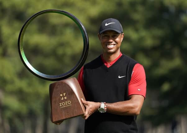 Tiger Woods shows off the trophy after his win in the Zoxo Championship in Japan. Picture: AP