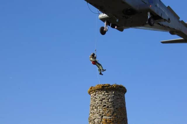 Police, fire and ambulance have been scrambled to the scene, with a helicopter hovering near the top of Dixon's Chimney in Carlisle, Cumbria.