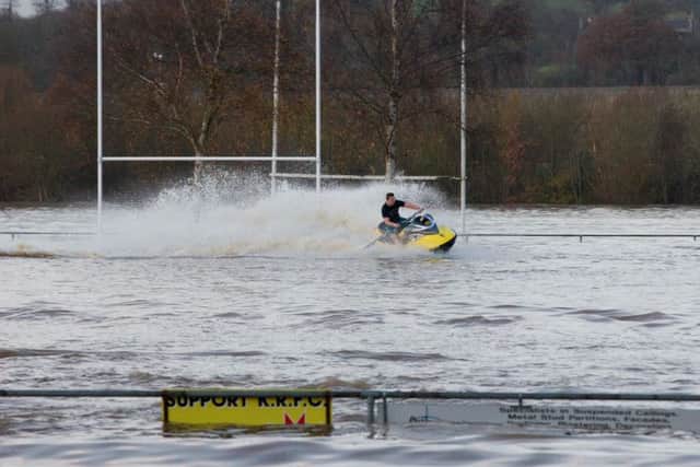 A jetskier plays on flooded rugby pitches in Keynsham, Somerset (Picture: SWNS)