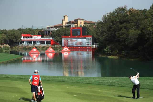 Bob MacIntyre hits his second shot at the 18th hole at Sheshan International en route to a two-under-par 70 in the first round of the WGC-HSBC Champions. Picture: Andrew Redington/Getty Images