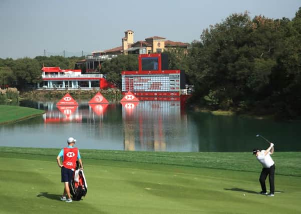 Bob MacIntyre hits his second shot at the 18th hole at Sheshan International en route to a two-under-par 70 in the first round of the WGC-HSBC Champions. Picture: Andrew Redington/Getty Images